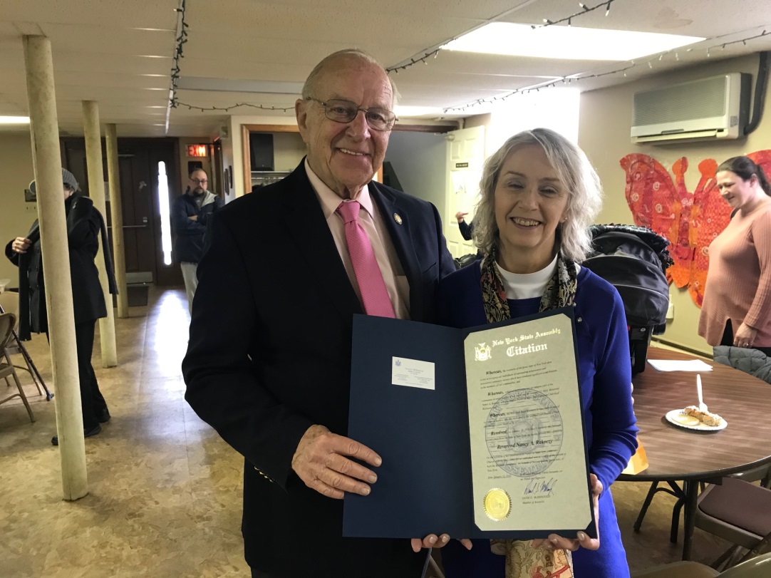 Assemblyman Dave McDonough presents Rev. Nancy A. Rakoczy with an official Assembly Citation recognizing her work and achievements.