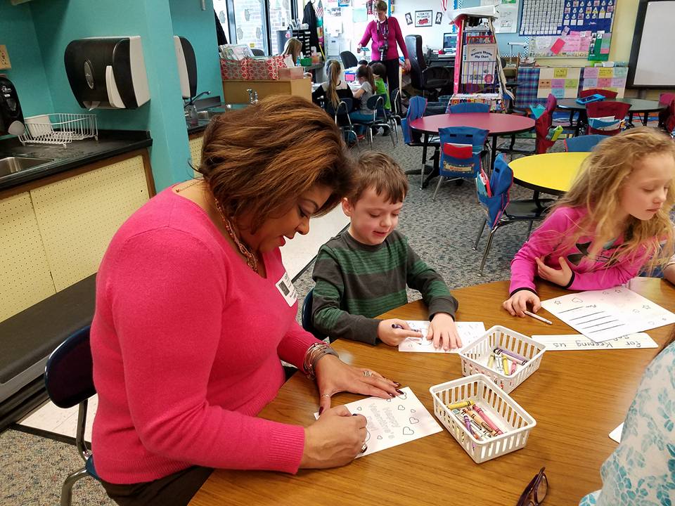 Assemblymember Hunter making valentines for veterans with kids from local school across her district.